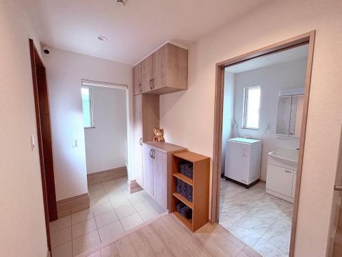a small kitchen with a sink and a refrigerator at SAKURA HOTEL - Vacation STAY 35483v in Hanawadamachi