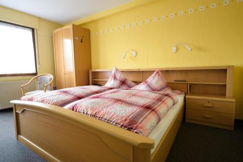 a bedroom with a bed with two pillows on it at Landgasthaus Pension Schmidthöfer in Berschweiler
