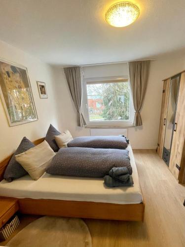 a bedroom with two beds and a window at Ferienwohnung Emma in Castrop-Rauxel