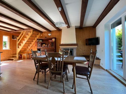 a dining room with a table and chairs at Juka in Palanga