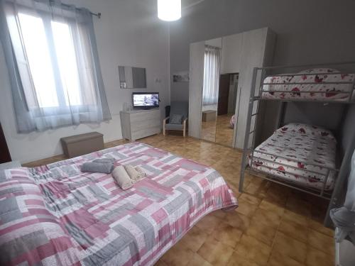 a bedroom with a bed and a bunk bed and a mirror at A casa di Irene in Le Marmore