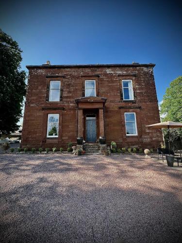 a brick house with a door on the front at Wigtown House in Wigtown