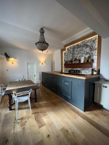 a kitchen with a table and a counter and a table and chairs at Wigtown House in Wigtown