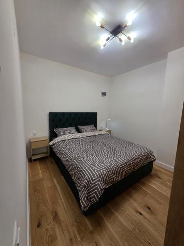a bedroom with a bed and a ceiling fan at XTN Chill House Aeroport with parking in Cluj-Napoca