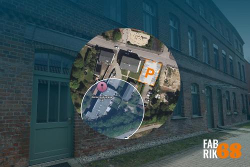 a rendering of a building with a circle on the side at Fabrik68 - ganzes Haus 3 Schlafzimmer 2 Bäder in Peitz