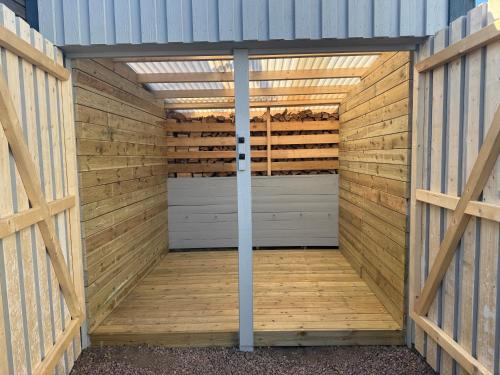 a wooden shed with a door in the middle at Gamletull Guesthouse in Halmstad