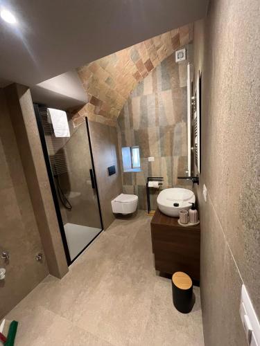 a bathroom with a toilet and a sink and a shower at A Casa di Costanza in Atri