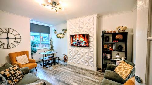 a living room with a couch and a fireplace at The road to Wigan Pier in Pemberton