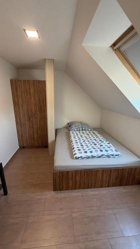 a bed in the attic of a room at Ubytování Divišov in Divišov