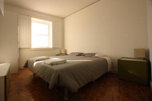 a bedroom with a bed with towels on it at Porto Riverside in Porto