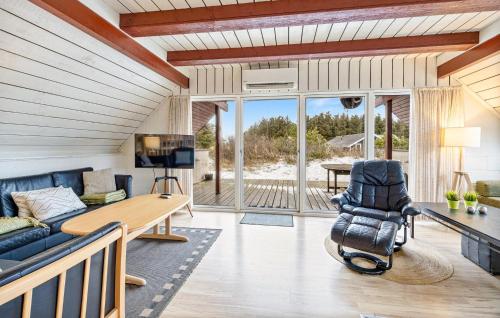 a living room with a couch and a table at Holiday Home Tingodden Iv in Hvide Sande