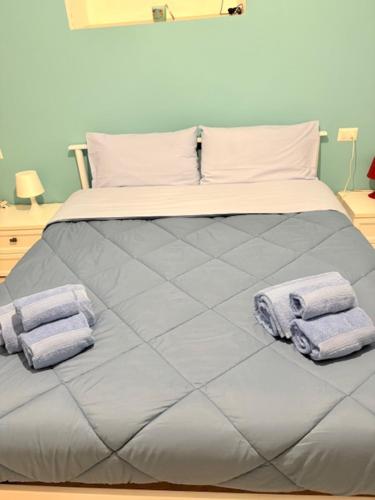 a bed with two towels on top of it at Levante al porto in Bisceglie
