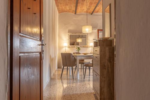 a hallway leading to a dining room with a table at Dimora San Lazzaro Tuscany in Cetona