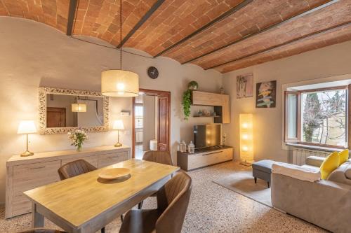 a living room with a table and a couch at Dimora San Lazzaro Tuscany in Cetona