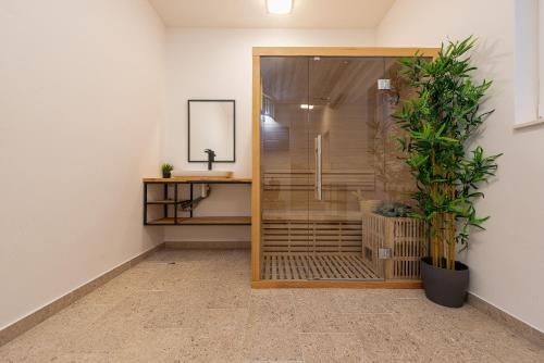 a shower stall in a room with a plant at Villa Ursula in Pakoštane