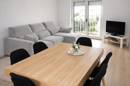 a living room with a table and a couch at Market Apartment - VPA in Vila Praia de Âncora