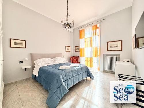 a white bedroom with a bed and a chandelier at See The Sea B&B in Salerno