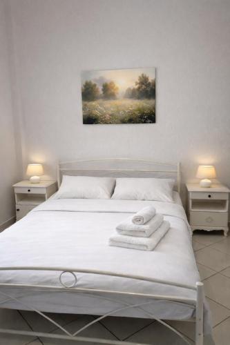 a bedroom with a bed with towels on it at Private Villa Sea View BBQ in Epanomi