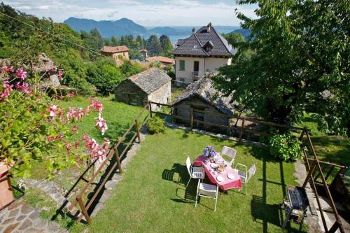 a table and chairs in the yard of a house at Casetta dei Lupi in Miazzina