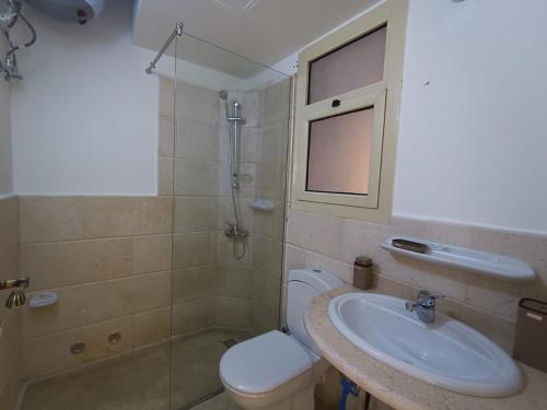 a bathroom with a toilet and a sink at OrientalCoast in Quseir