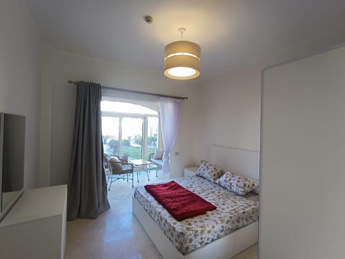 a bedroom with a bed and a dining room at OrientalCoast in Quseir