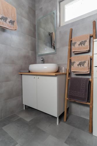 a bathroom with a sink and a mirror at Lagom Vendégház in Zalaszentgrót