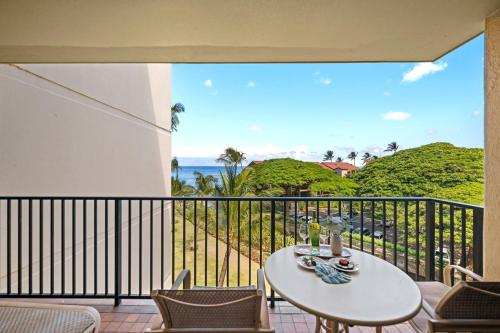 a balcony with a table and chairs and the ocean at Kaanapali Shores 512 in Kaanapali