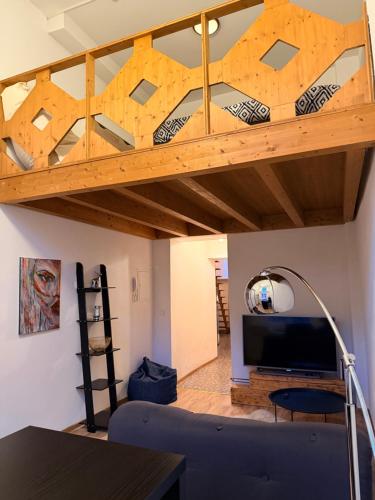 a loft bed in a living room with a couch at Loft in Viljandi Old Town in Viljandi