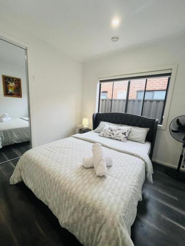 a bedroom with a large bed with two pillows on it at My Home II in Tarneit
