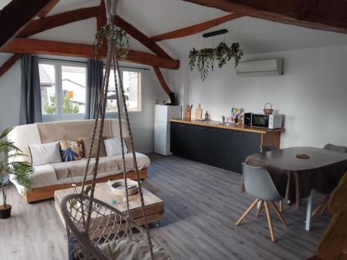a living room with a couch and a table at La Cabane aux Hirondelles in Entraigues