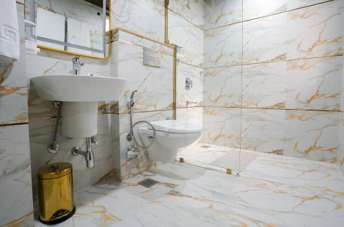 a bathroom with a toilet and a sink at Five Palms Hotel in Gurgaon