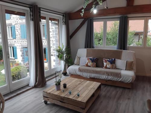 a living room with a couch and a coffee table at La Cabane aux Hirondelles in Entraigues