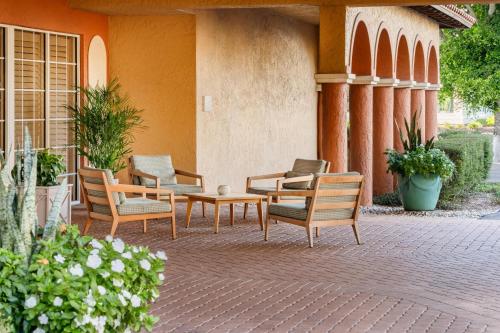 a group of chairs and a table on a patio at Inn of Naples, Tapestry Collection by Hilton in Naples