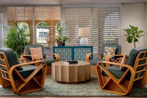 a lobby with chairs and a coffee table at Inn of Naples, Tapestry Collection by Hilton in Naples