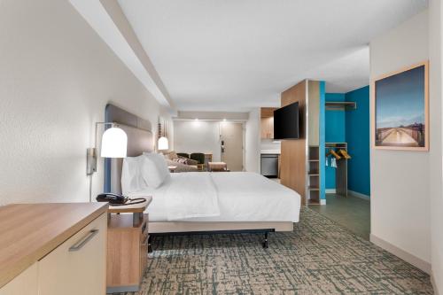 a hotel room with a bed and a kitchen at Homewood Suites by Hilton Oklahoma City Airport in Oklahoma City