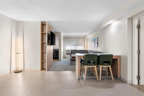 a kitchen and dining room with a table and chairs at Homewood Suites by Hilton Oklahoma City Airport in Oklahoma City