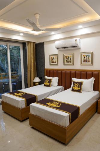 two beds in a hotel room with at Five Palms Hotel in Gurgaon