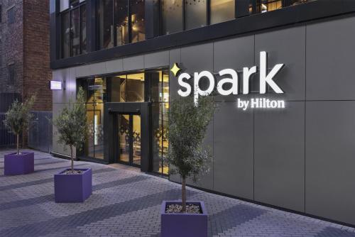 a spark building with potted trees in front of it at Spark by Hilton London Romford in Romford