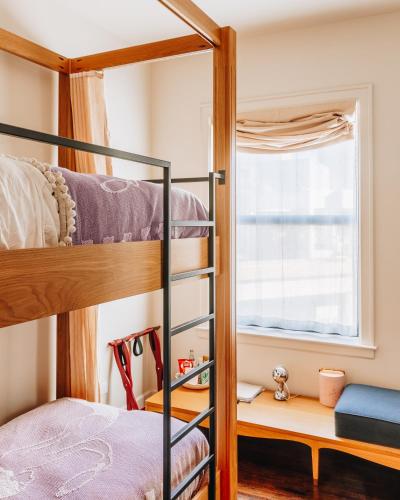 a bedroom with bunk beds and a window at The Siren Hotel, an Ash Hotel in Detroit