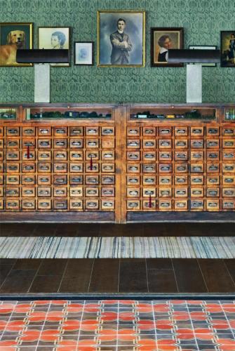 a large wooden cabinet filled with lots of cards at Graduate by Hilton Charlottesville in Charlottesville