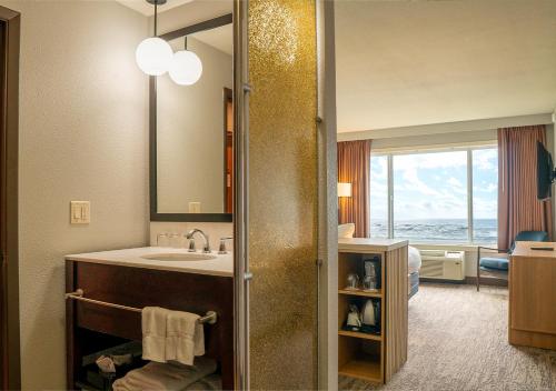 a bathroom with a sink and a mirror at The Coho Oceanfront Lodge in Lincoln City