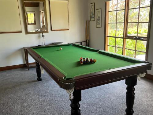 a green pool table with balls on top of it at David's at Hillcrest in Anglesea