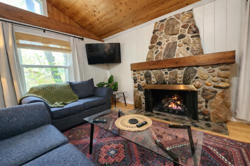 a living room with a couch and a fireplace at Steps to Beach-Hot Tub-Fireplace-Northern Original in Traverse City