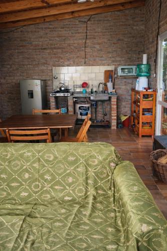 a living room with a table and a kitchen at Finca Santiago in San Miguel del Monte