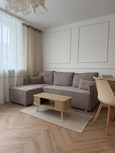 a living room with a couch and a coffee table at Apartament pod Ratuszem - Kluczbork in Kluczbork