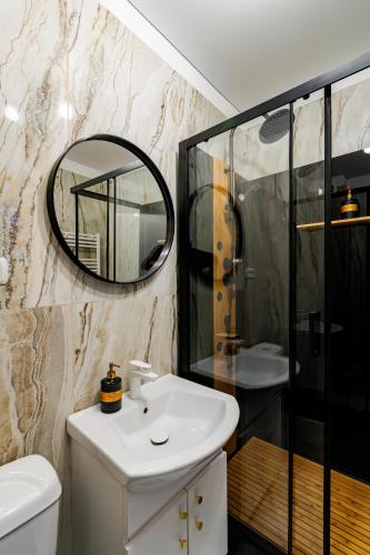 a bathroom with a sink and a mirror at SECRET JACUZZl & LOVE in Bucharest