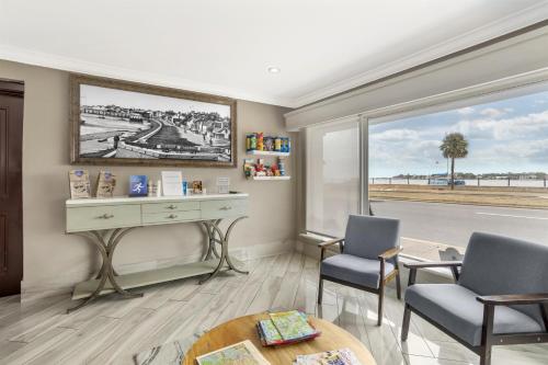 a room with two chairs and a desk and a window at Best Western Historic Bayfront in St. Augustine
