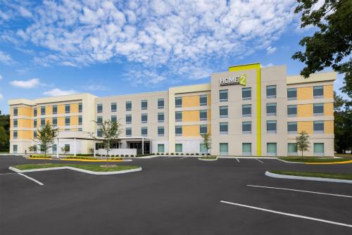 an office building with a parking lot at Home2 Suites By Hilton Virginia Beach Princess Anne in Virginia Beach