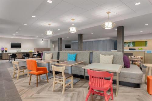 a waiting room with colorful chairs and tables at Home2 Suites By Hilton Virginia Beach Princess Anne in Virginia Beach