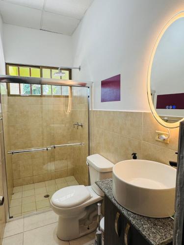 a bathroom with a toilet and a sink and a shower at Casa Yasmin in San Mateo